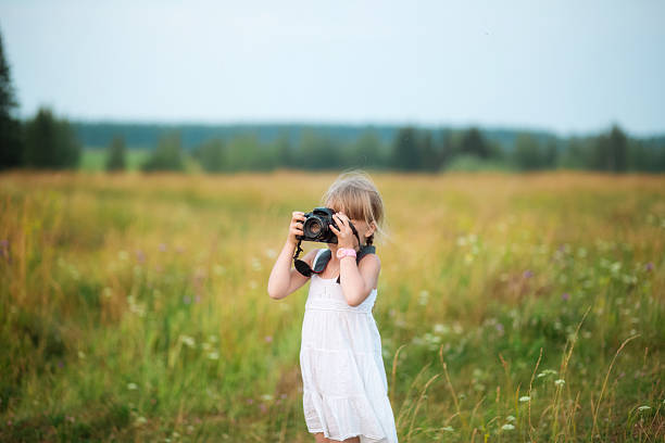 istock Little girl with a camera 612226102