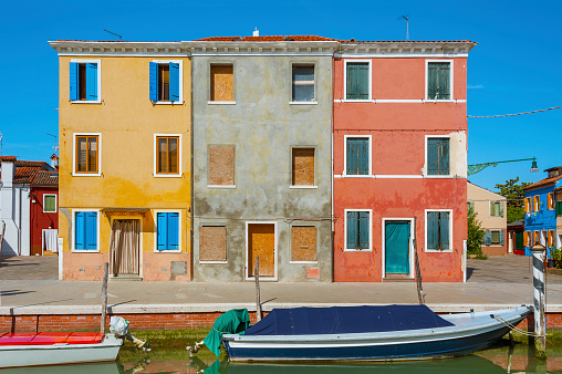 Colorful residential buildings and canal in Burano island, Venice, Italy.