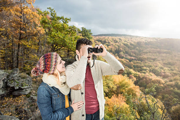 istock Young couple on a walk in sunny autumn forest 612229416
