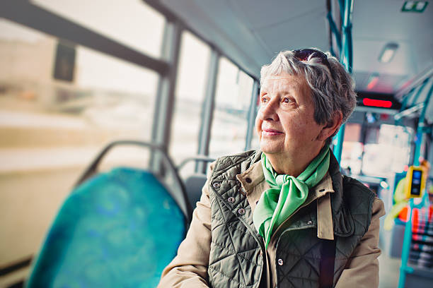 senior woman in the bus - bus transportation indoors people imagens e fotografias de stock