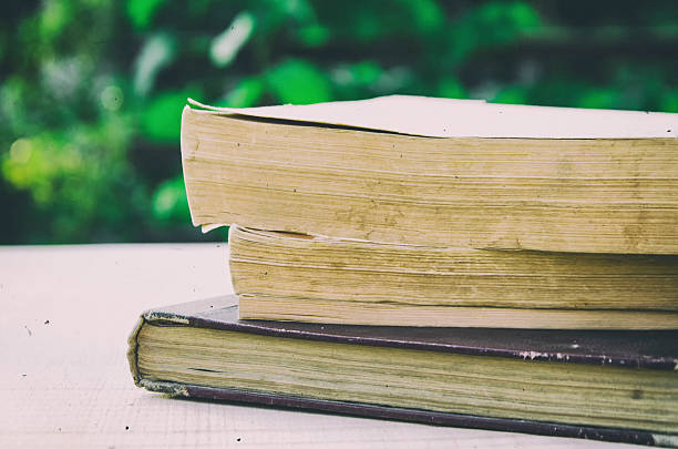 istock stack of old books in the garden 612232324