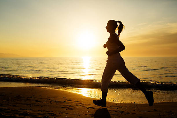 istock Caucasian woman jogging at seashore 612232436
