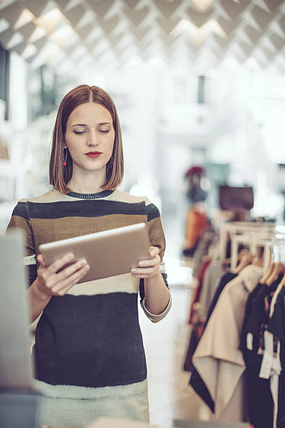 istock Young businesswoman is working in her store 612233232
