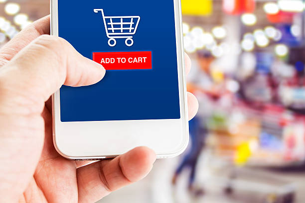 istock Hand holding mobile with blur customer at supermarket store 612233318