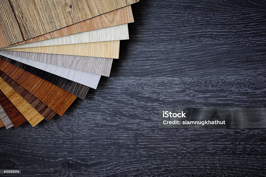 Sample pack of wooden flooring laminate on wooden black floor wood texture floor Flooring Stock Photo