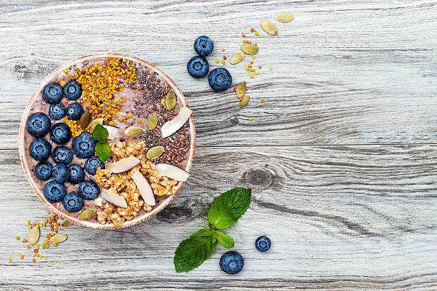 Acai breakfast superfoods smoothies bowl with chia seeds, bee pollen stock photo