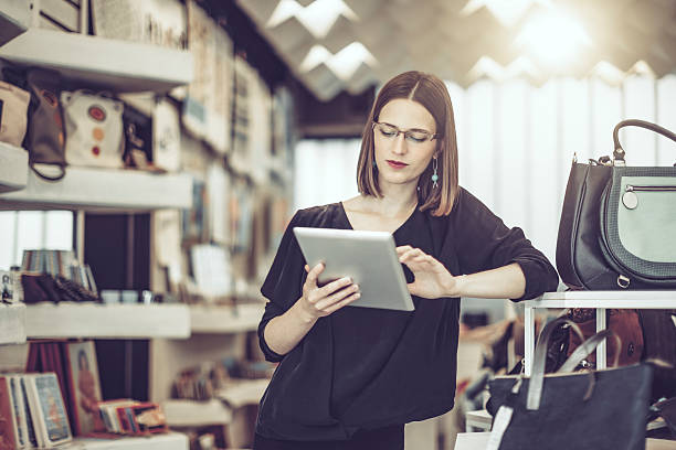 istock Young businesswoman is working in her store 612234554