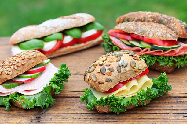 sandwiches  - mozzarella tomato sandwich picnic stock-fotos und bilder