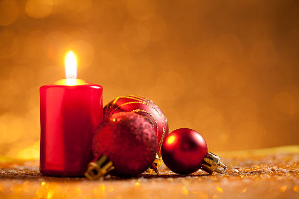 istock Candle and bauble on glitter with gold background 612234860