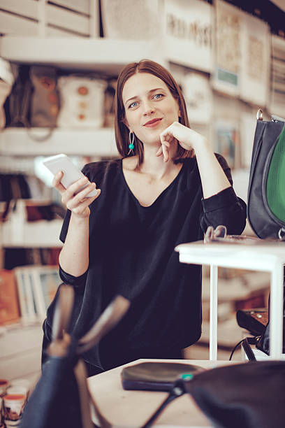 istock Young businesswoman is working in her store 612235122
