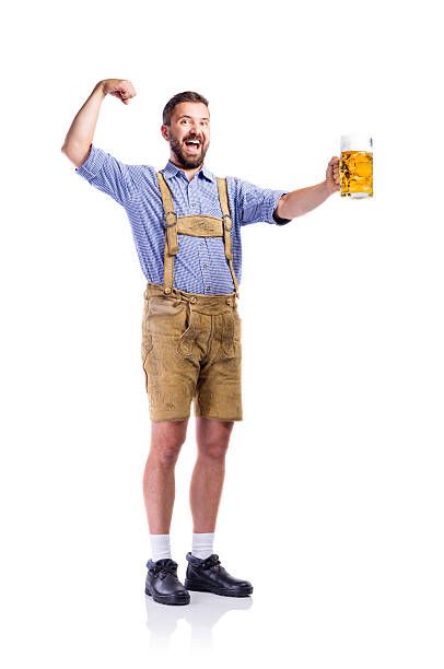 istock Man in bavarian clothes, holding beer, showing biceps 612235226