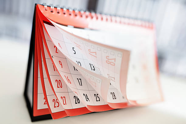 Calendar Months and dates shown on a calendar whilst turning the pages busy calendar stock pictures, royalty-free photos & images