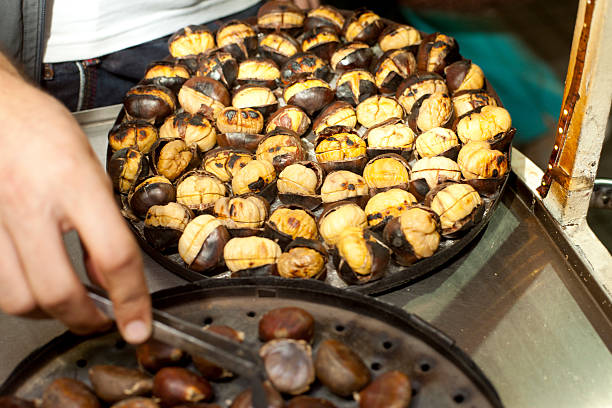 istock Someone grilles the chestnuts in the shell 612235930