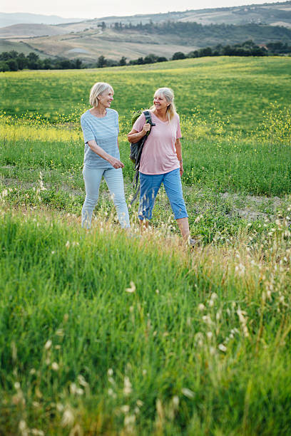 istock Senior Women Outdoors Walking with a Backpack 612236770