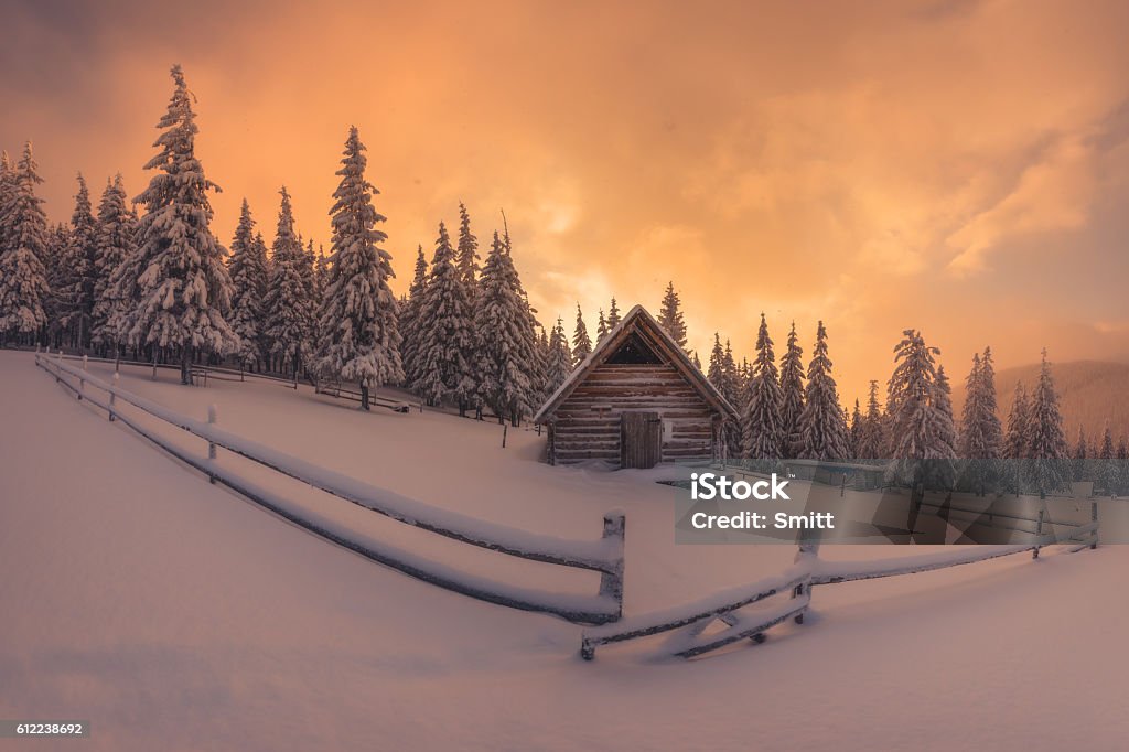 House Fantastic pink evening landscape glowing by sunlight. Dramatic wintry scene with snowy house. Carpathians, Ukraine, Europe. Christmas Stock Photo