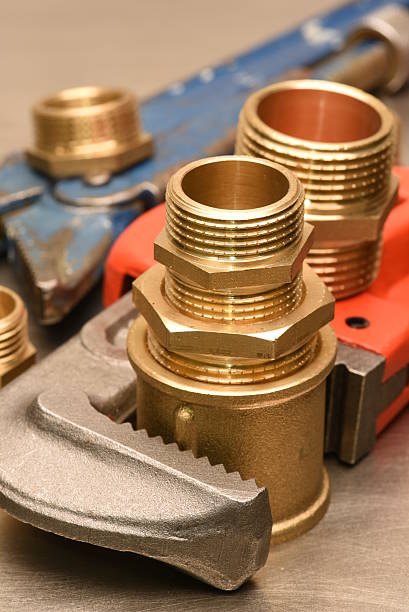 istock Wrench and brass fittings 612240360