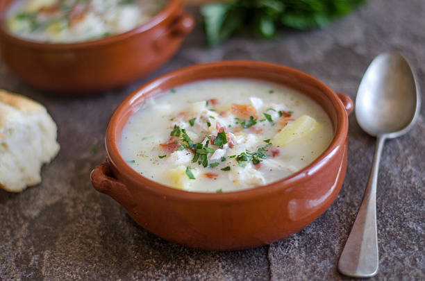Smoked haddock chowder Smoked haddock chowder topped with crispy bacon Chowder stock pictures, royalty-free photos & images