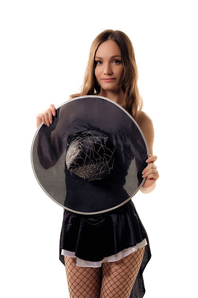 istock young woman in a black halloween costume posing in studio 612243788