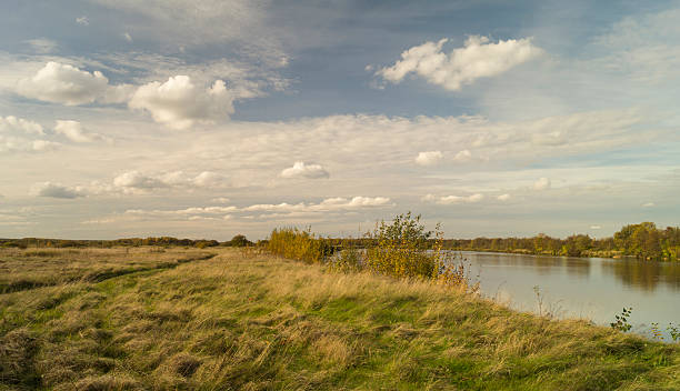 istock Autumn landscape with river on background sky 612244766