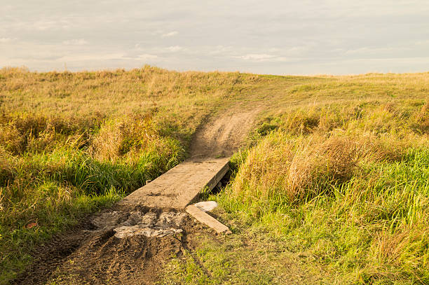 istock Autumn landscape with bridge through creek 612247744
