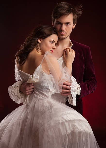 Beautiful couple of vampires dressed in medieval clothing. Beautiful couple of vampires dressed in medieval clothing. book cover tail coat photos stock pictures, royalty-free photos & images
