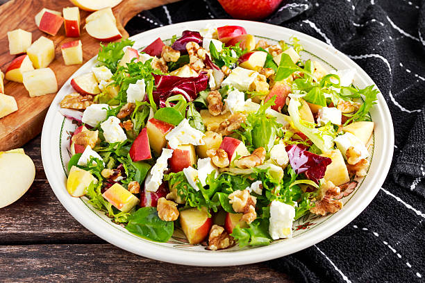 istock Light Fresh Home made fruit apple salad with walnuts, vegetables 612250674