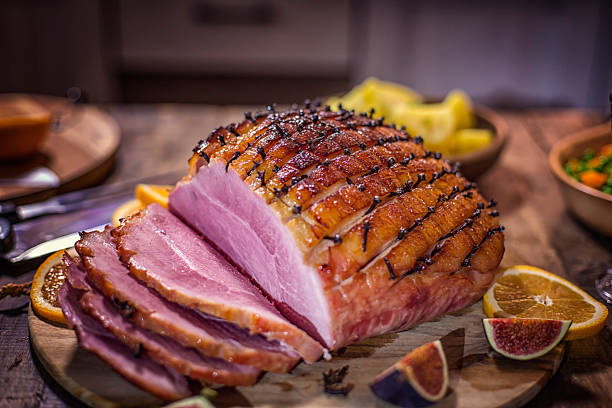 istock Glazed Holiday Ham with Cloves Served for Dinner 612251236