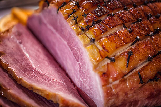 istock Glazed Holiday Ham with Cloves Served for Dinner 612251460