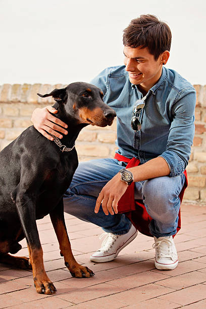 istock Young man and his dog - Doberman 612251550
