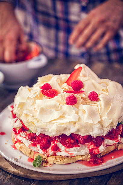 istock Preparing Berry Pavlova Cake with Strawberries and Raspberries 612251888