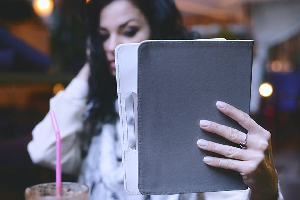 istock Woman hand holding a Tablet device 612252036