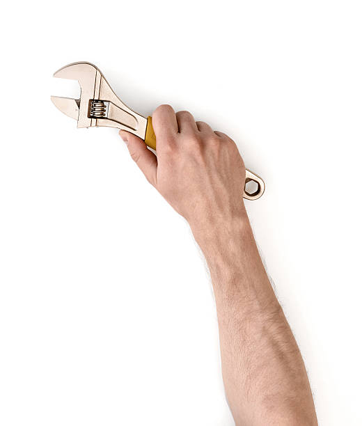 visão de perto da mão de um homem segurando ajustável - adjustable wrench wrench isolated spanner - fotografias e filmes do acervo