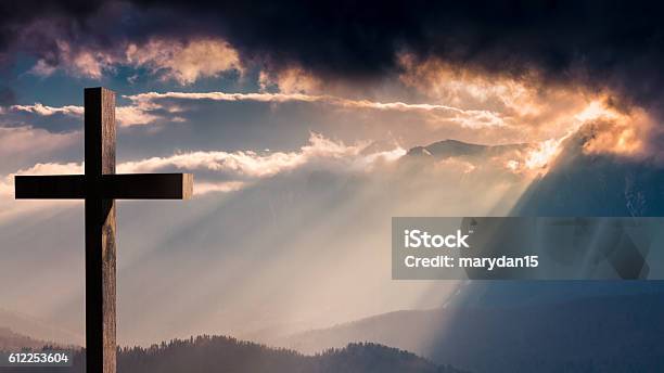 Jesus Christ Wooden Cross On A Dramatic Colorful Sunset Stock Photo - Download Image Now