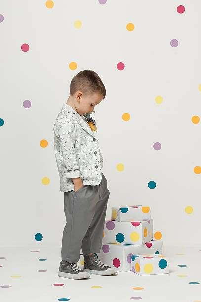 istock little boy in a suit 612254416