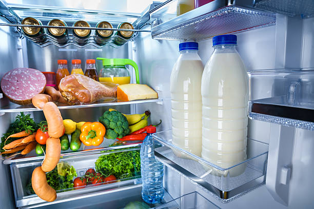 Open refrigerator filled with food stock photo