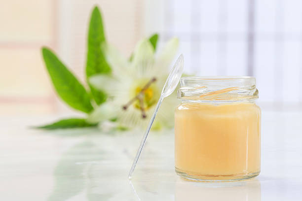 raw organic royal jelly in a small bottle with passiflora stock photo