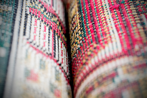 Close up detail of two rolled up prayer mats side by side. 