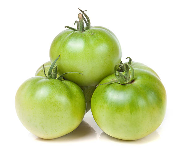 istock Three green unripe tomato isolated on white background 612258748