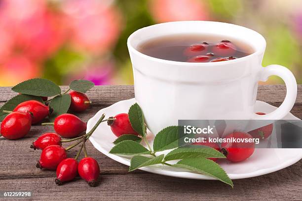 Cup Of Tea Rosehip Berries On A Dark Wooden Background Stock Photo - Download Image Now