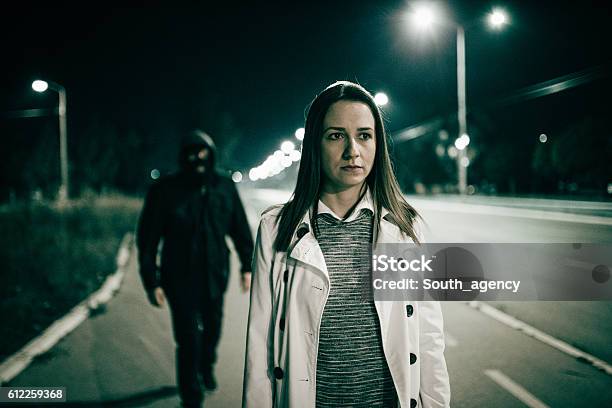 Robber Walking Behind A Girl Stock Photo - Download Image Now - Women, Following - Moving Activity, Street