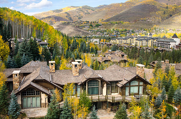 Mountain Resort Village of Vail, Colorado in the Rocky Mountains The famous ski village of Vail, Colorado. The village was established and built as the base village to Vail Ski Resort, with which it was originally conceived and is the third largest ski mountain in North America. Vail attracts wealthy visitors, many of whom, who build and purchase vacation homes and condominiums near the ski slopes. Taken in Vail, Colorado in early October. aspen tree stock pictures, royalty-free photos & images