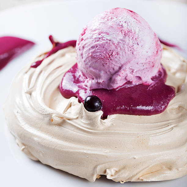 istock Meringue with berry ice cream on a white plate 612260242