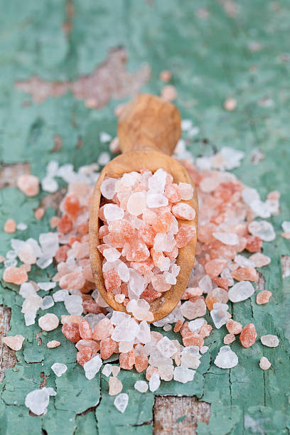 istock pink salt on old wooden surface 612260706