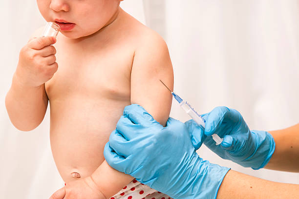 istock doctor vaccinating baby 612260964