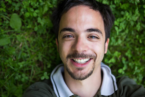 istock Man smiling on the clover field,making selfie 612262484