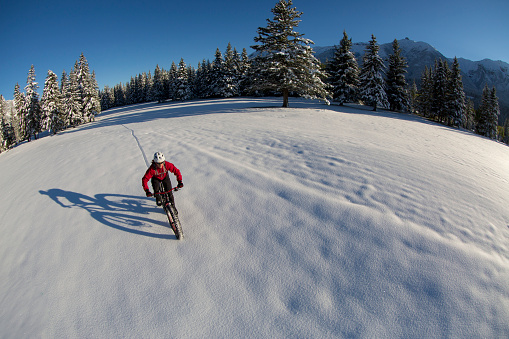 A man enjoys a wintertime fat bike ride in the Rocky Mountains of Canada.