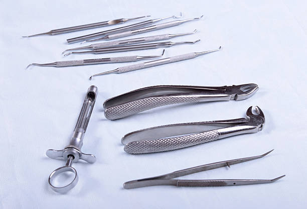 istock Medical instruments for dentists on blue table 612264328