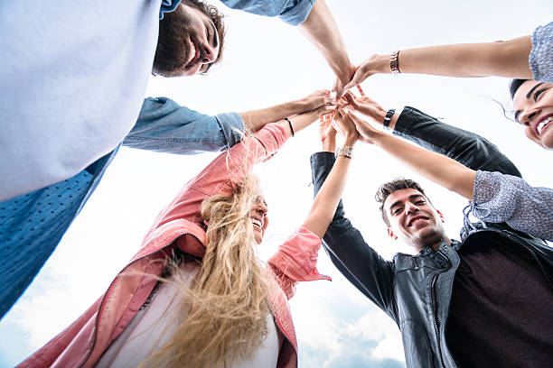 istock happiness all together with arm raised outdoors in barcelona 612264756