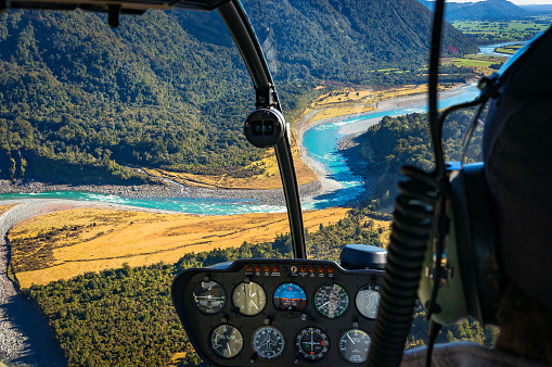 View from helicopter on beautiful landscape of mountain river. Whataroa, South Island, New Zealand. Selective focus on landscape