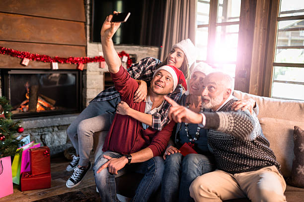 all the family taking a selfie for christmas all the family taking a selfie for christmas multi generation family christmas stock pictures, royalty-free photos & images
